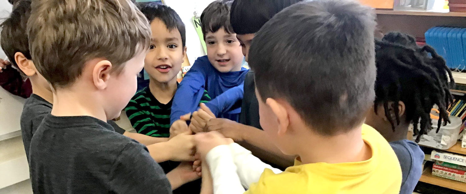 Children putting their hands together